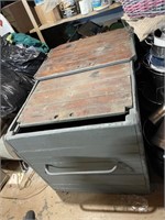large gray wooden box with sliding top doors