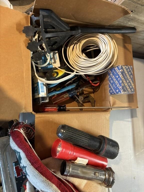 box of wire, chain pieces, 3 flashlights, concret