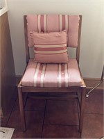 Striped upholstered chair with pillow
