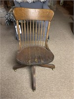 Old oak office chair on rollers - seat cracked