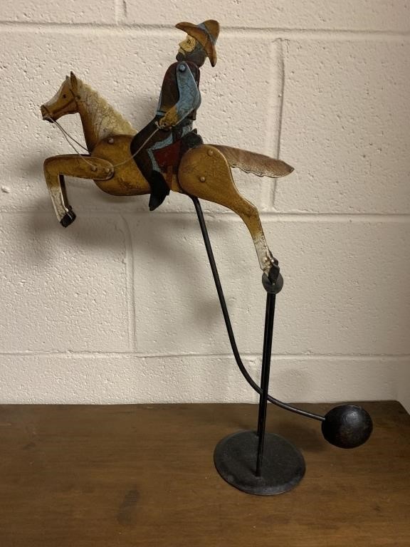 Pendulum swinging horse with cowboy