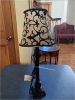 Black candlestick lamp with black and white shade