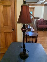 Tall candlestick lamp with burgandy shade