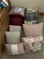 12 pillows:  3 burgandy, 2 geometric design, 5
