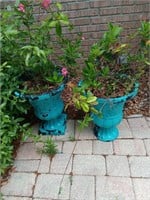 2 plastic planters with plants, 19 inches tall.