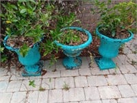 3 plastic planters with plants, 19 inches tall.