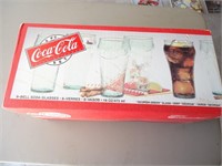 (E3) 8 new coke glasses in box.  Bell soda