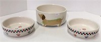 Lot of three ceramic dog food and/water dishes.
