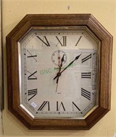 Wooden framed clock by Howard Miller Company
