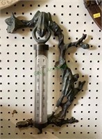 Outdoor temperature gauge featuring frogs on a