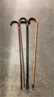 Four canes - three are shepherd hook type wooden