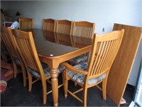 Oak dinning room table 8 chairs glass top and lea.