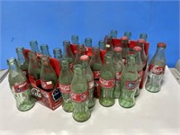 27 Coca-Cola Bottles and 3 Cardboard Carriers