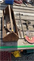 Wooden tool box with garden shears, saw blades.