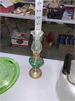 small green hurricane oil lamp