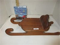 Wooden sled and Christmas shoes book