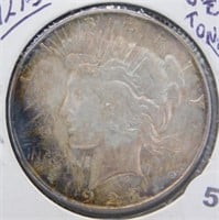 1927-S UNC and Toning Peace Silver Dollar.