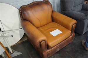large leather armchair with brass tacks