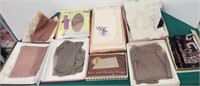 Boxes of nylons, scarfs, placemats, etc