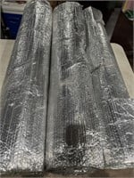 Three partial rolls of metal roofing insulation