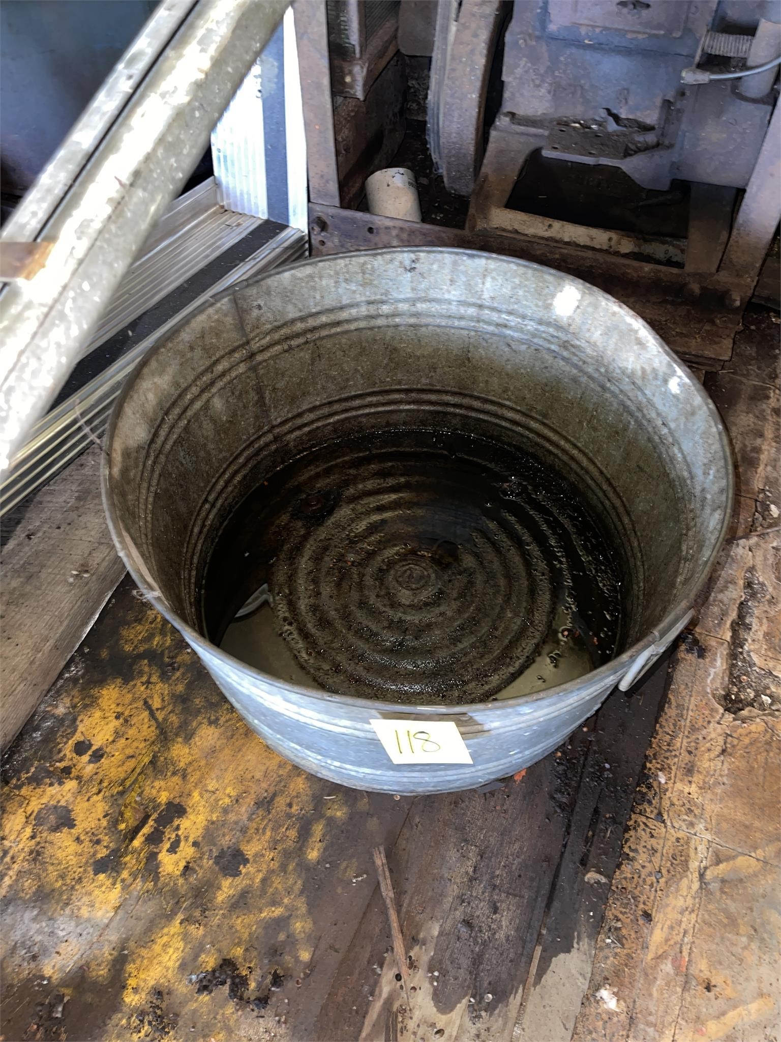 galvanized basin has a little oil in it