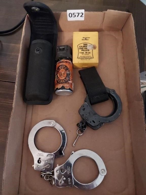 Lot of Handcuffs, pellets, and Pepper Spray.