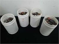 Four plastic 6.5 in containers with rocks /