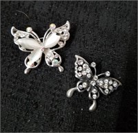 Two beautiful butterfly pins one of the stones