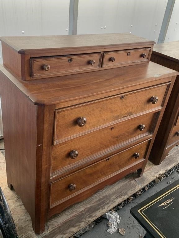 Antique wooden dresser with vanity drawers on a tw
