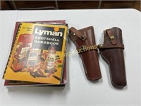 TWO SINGLE ACTION LEATHER HOLSTERS AND BOOKS