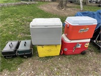 4 COOLERS AND 2 TAILGATE GRILLS