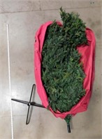 large Christmas tree in red bag