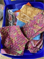 2 toes of fabric and 1 tote with an assortment of