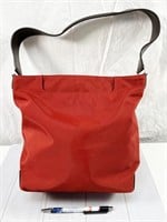 Tumi zipper-top canvas handbag in red, with