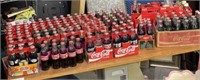 Large lot of Coke bottles (mainly full)