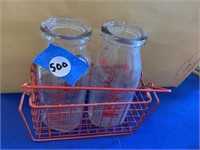 PAIR OF VINTAGE GLASS MILK BOTTLES IN RED TRAY
