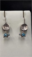 Silver coloured earrings with turquoise coloured