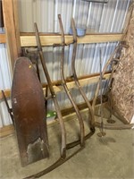 Antique iron board , scythes and other tools