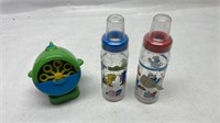 Two Sesame Street baby bottles and bubble blowing