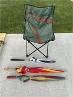 Folding chair and three umbrellas