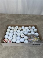 Golf balls and tees, some Titleist Pro V1