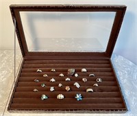 24 costume jewelry rings in display case