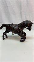 Carved wood horse with leather saddle