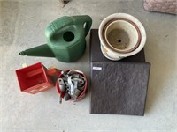 6 plastic landscaping pavers, pots, watering can