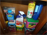 Contents of bottom cabinet, miracle grow, misc.