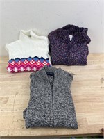 Three women’s sweaters medium/large