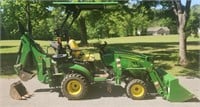 John Deere 1025 R with several attachments