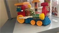 Small toy train, one small cootie toy still in