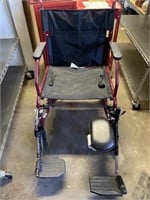 Excel Transport Wheelchair with leg rests and a