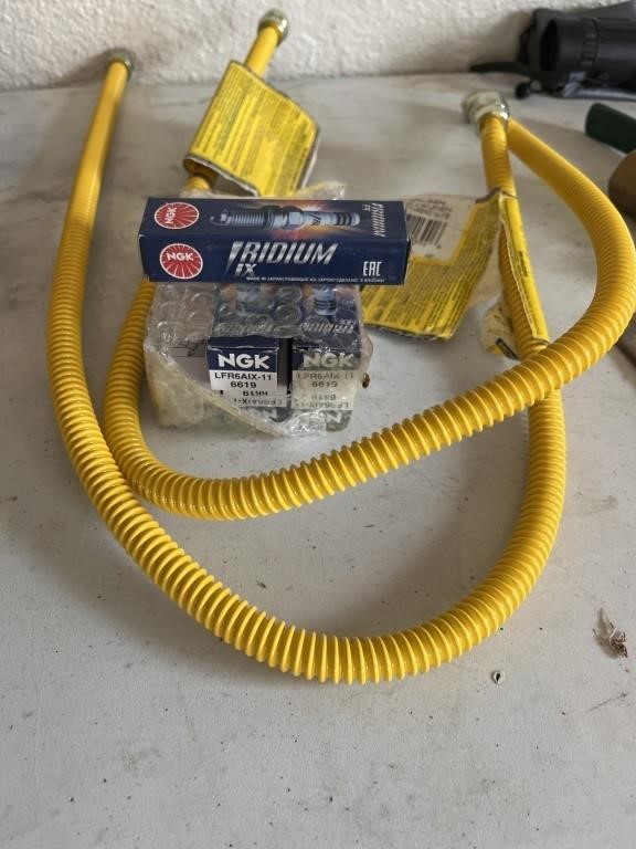 Two brand new gas connectors with new spark plugs